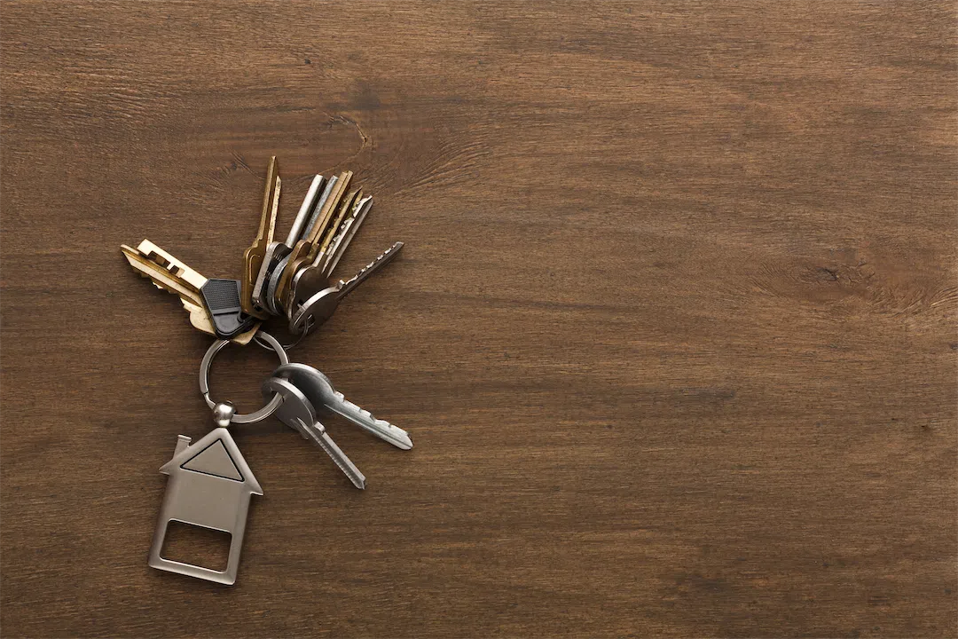 A set of house keys with a house-shaped keychain, symbolizing the legal process of eviction in Alaska.
